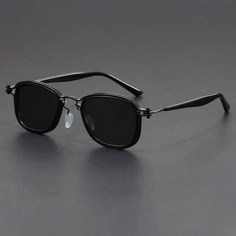 Retro square sunglasses with metal frame and tinted AC lenses in a two-tone colour option on a wooden surface.