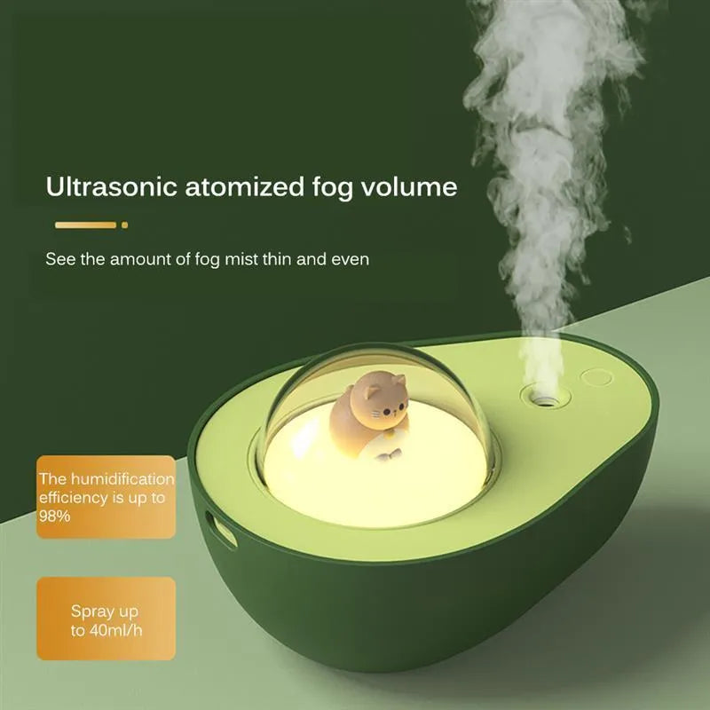 Green avocado-shaped mini humidifier with USB cable and night light on a desk