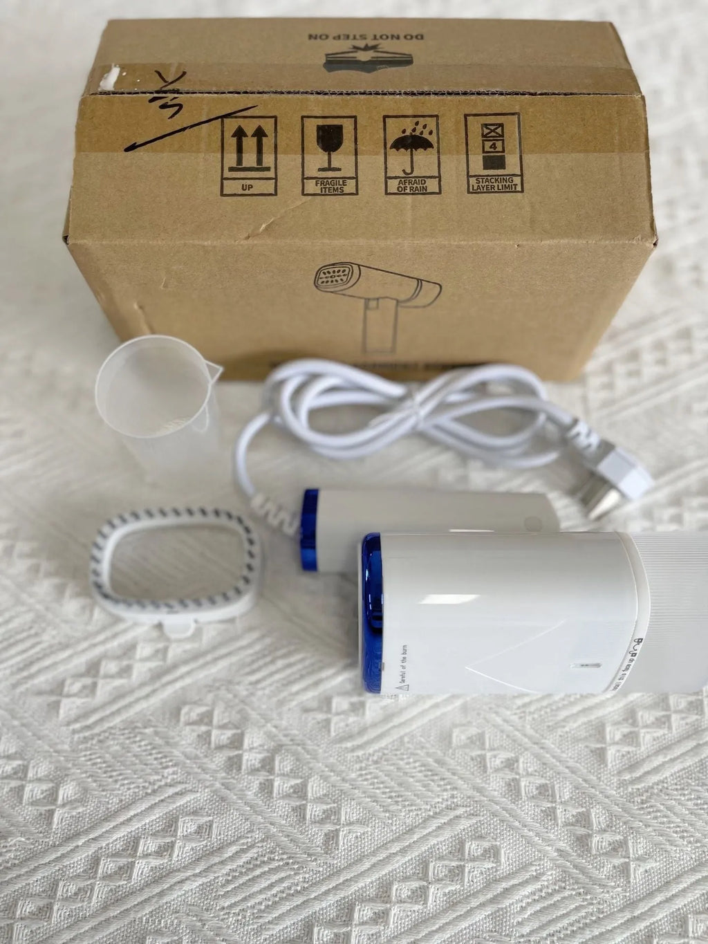 Portable handheld garment steamer in white foldable design with non-stick liner and UK plug