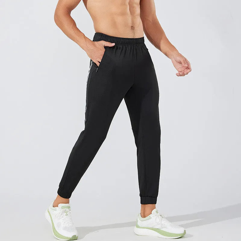 Men's black polyester running trousers with a mid-waist and full-length cut.
