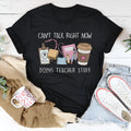 Black cotton short-sleeve t-shirt on a hanger, showing round neck and loose straight-cut silhouette.