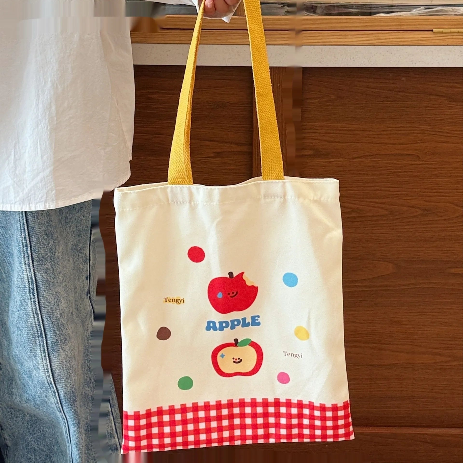 Cartoon print canvas handbag showing colourful design with 30x36x24cm dimensions