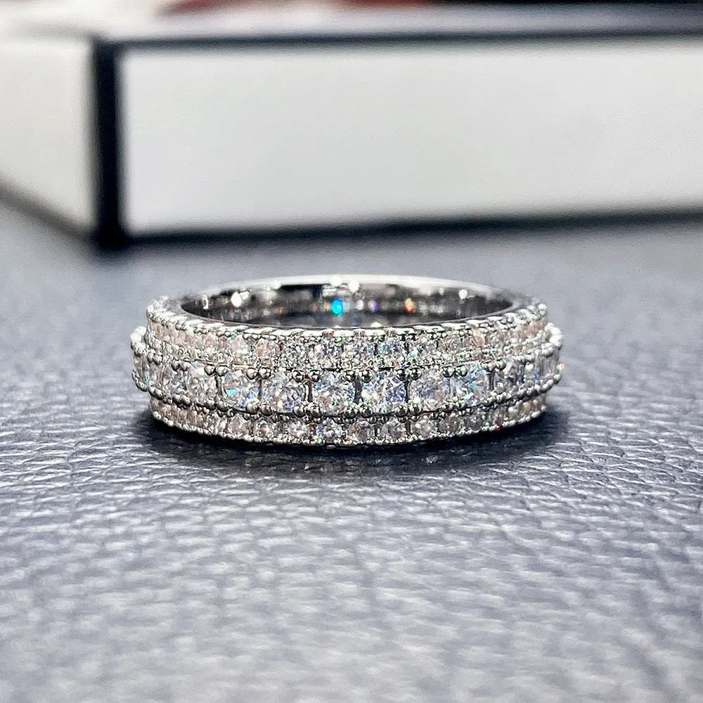 Geometric triangle personalised engagement ring with zircon inlay on copper, shown in a choice of finishes.