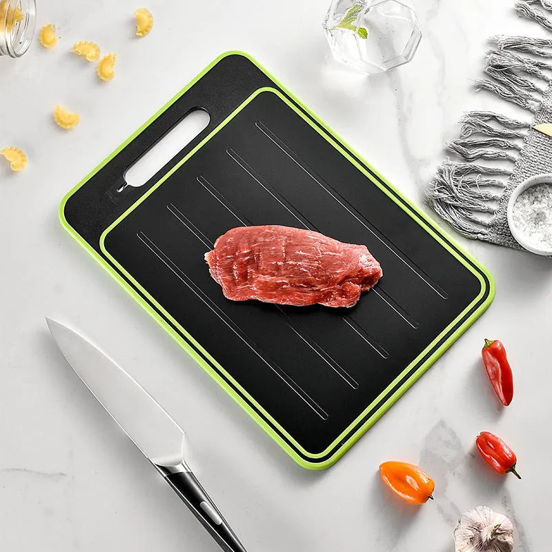 Grey square aluminium cutting board with defrosting side, grinder teeth, and integrated knife sharpener.