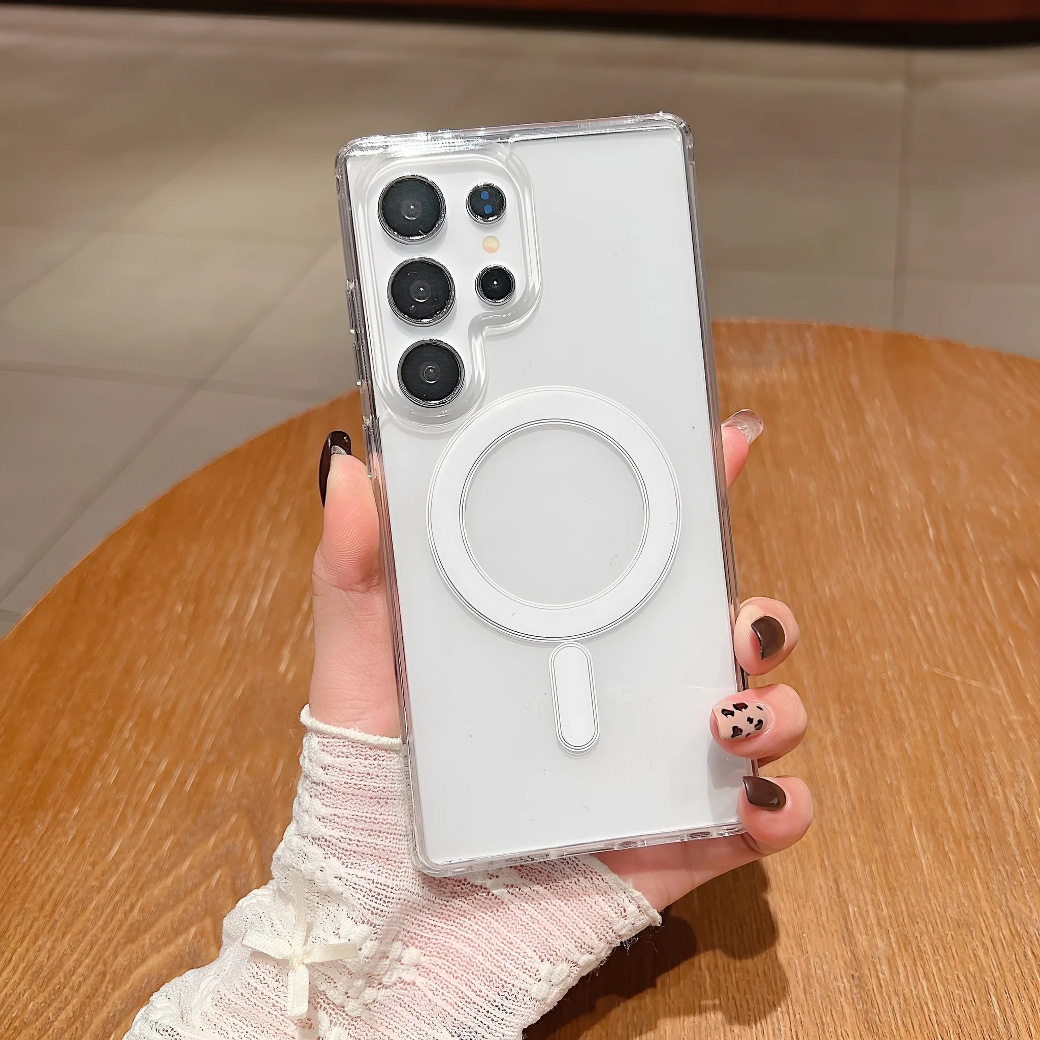 Transparent magnetic silicone phone case for Samsung Galaxy and A-series smartphones on a flat surface.