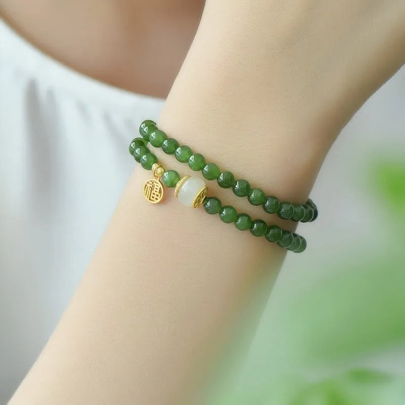 Women's double circle bracelet made from natural Hetian Jade, showing geometric shape and fu character detail.