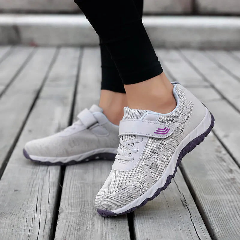 Women's low-top casual shoes with Velcro strap, wedge heel, and breathable mesh upper in a grey purple colour.