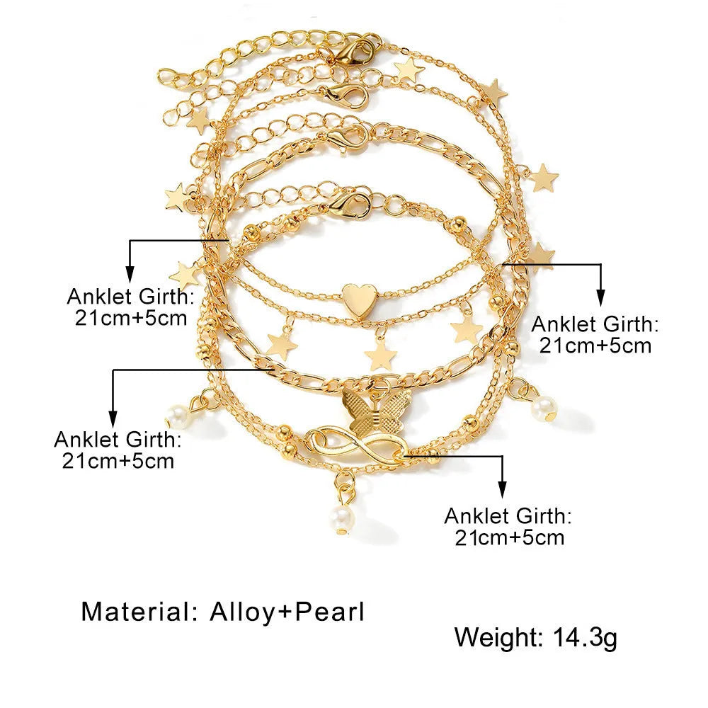 Set of four women's alloy anklets with butterfly and pearl heart designs arranged together