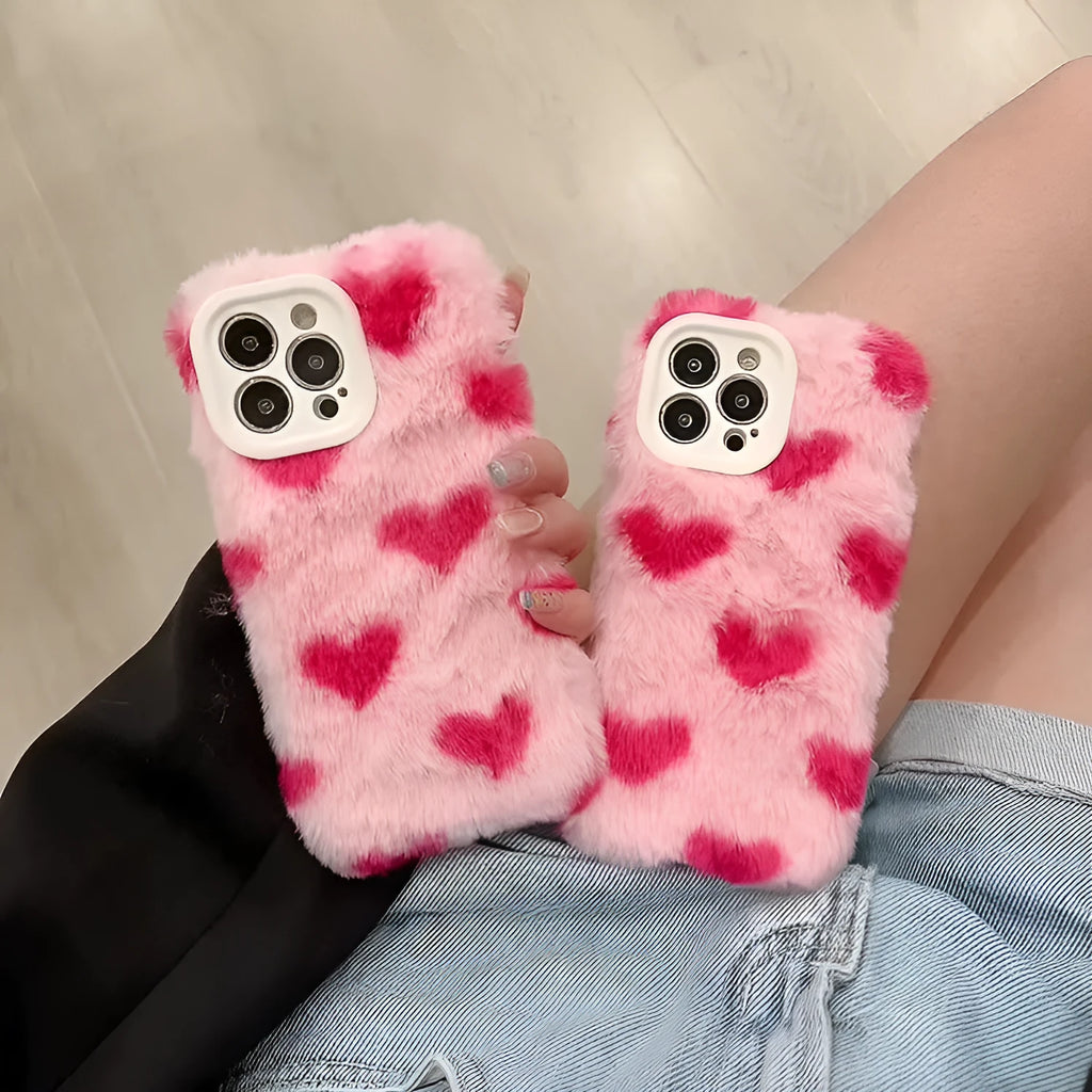 Pink silicone iPhone case with cartoon Love Plush design, shown fitted on a mobile phone.
