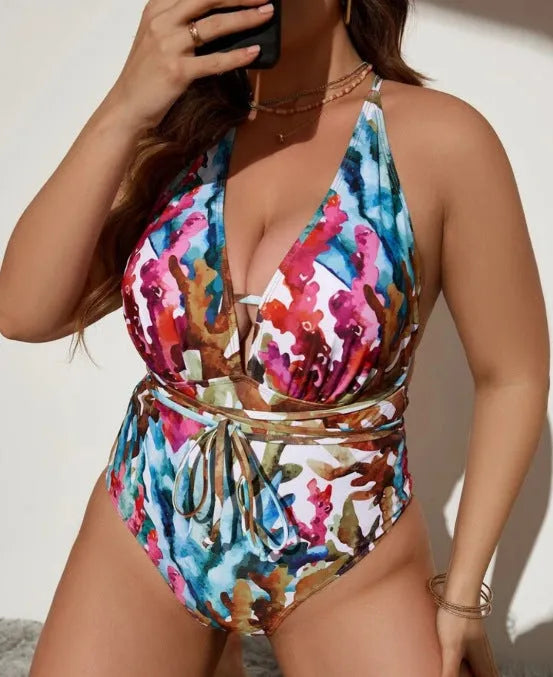 Women's solid blue halter neck one-piece swimsuit on a mannequin, showing the briefs style bottom.