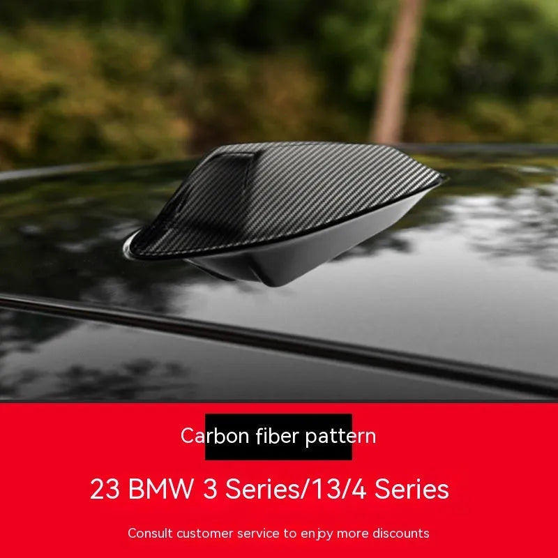 BMW shark fin antenna cover in carbon drill pattern and piano black finishes for Type A, B, and E models.