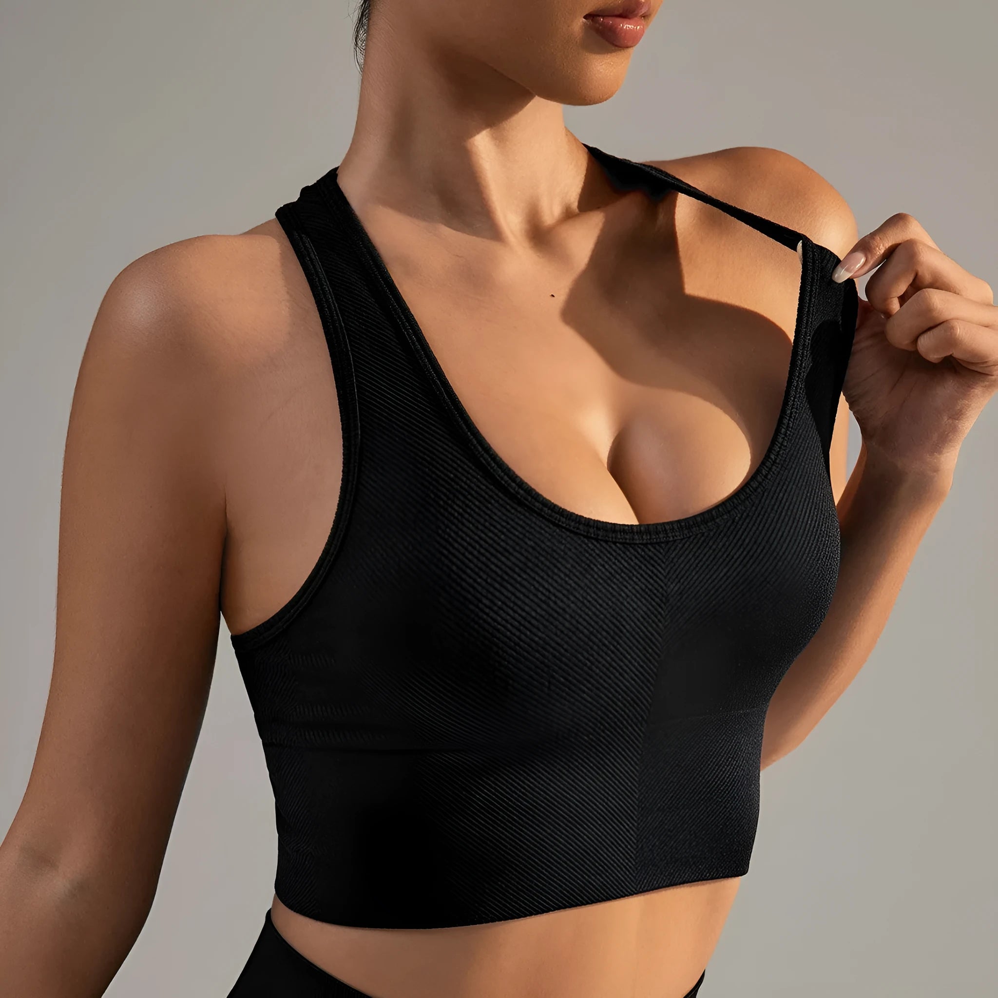Black women's sports bra with moulded cups and double-shoulder straps for running and yoga