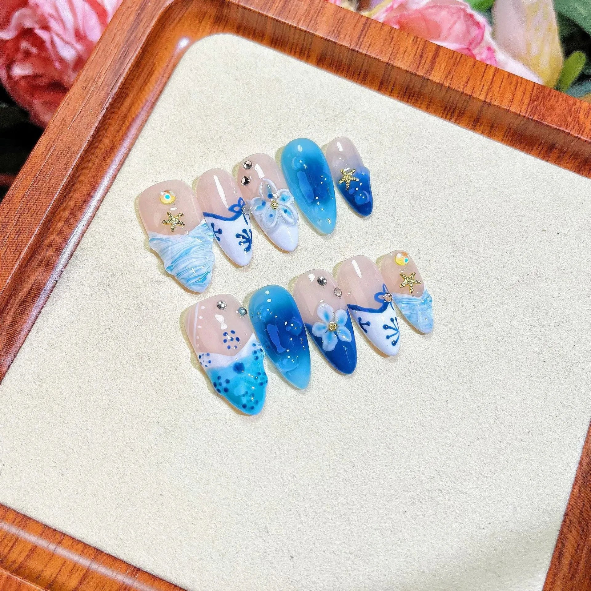 Blue hand-painted carved summer ice transparent plastic fake nails showing size range XS to L