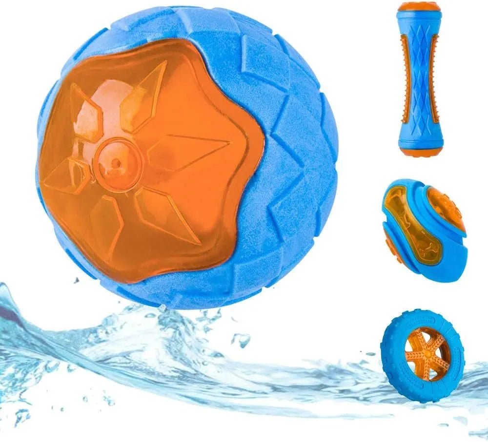 Set of four squeaky dog toys: a blue ball, a red barbell, and two orange tyres, shown on grass.