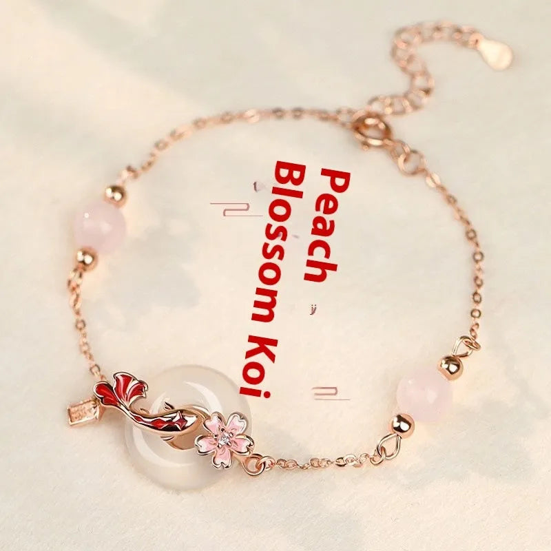Close-up of a women's S925 sterling silver bracelet with a white chalcedony crystal flower and koi-themed design.