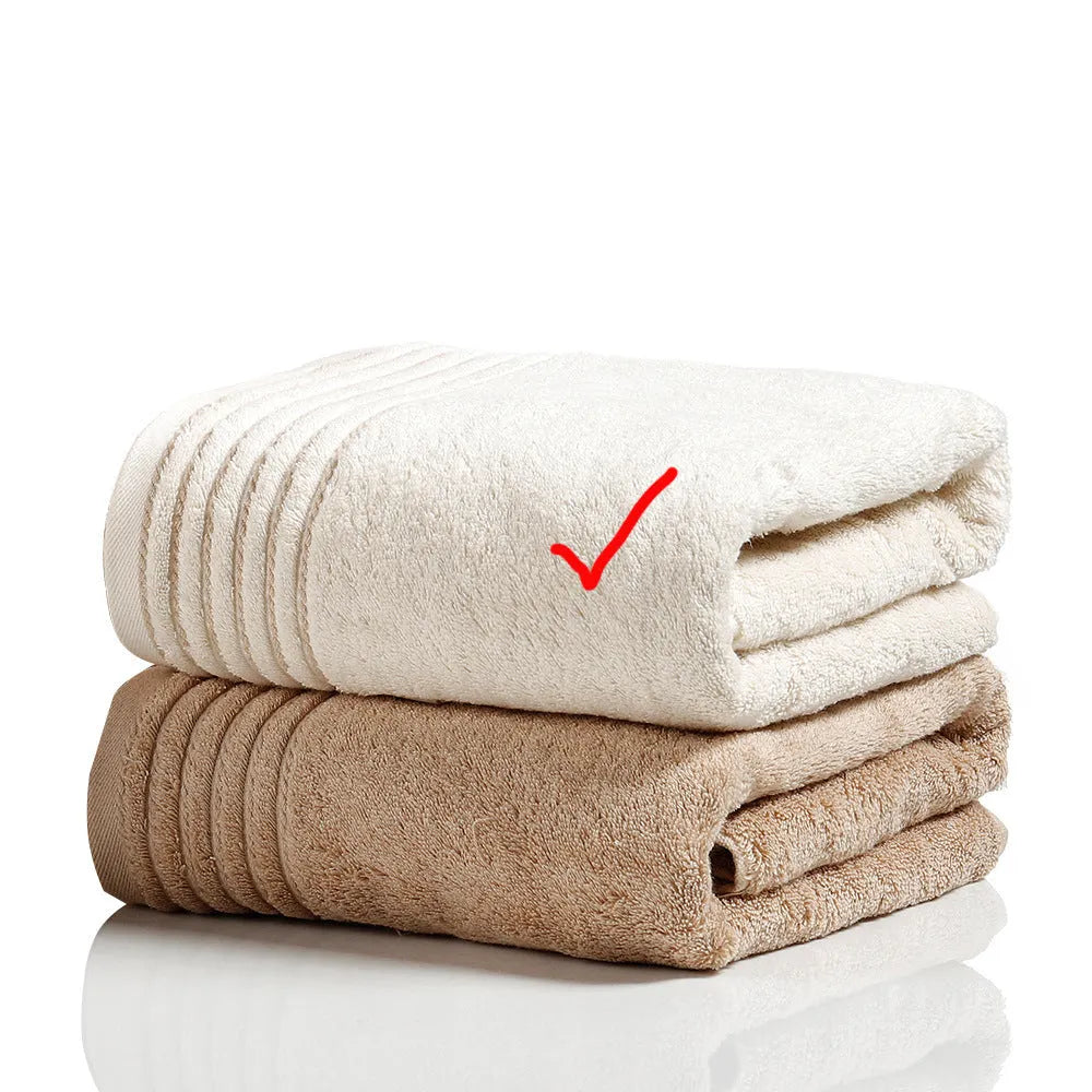 Cotton towel set in brown or beige showing bath sheet, hand towel, and face cloth sizes