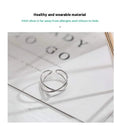 Silver plated geometric cross ring with an adjustable opening on a copper base.