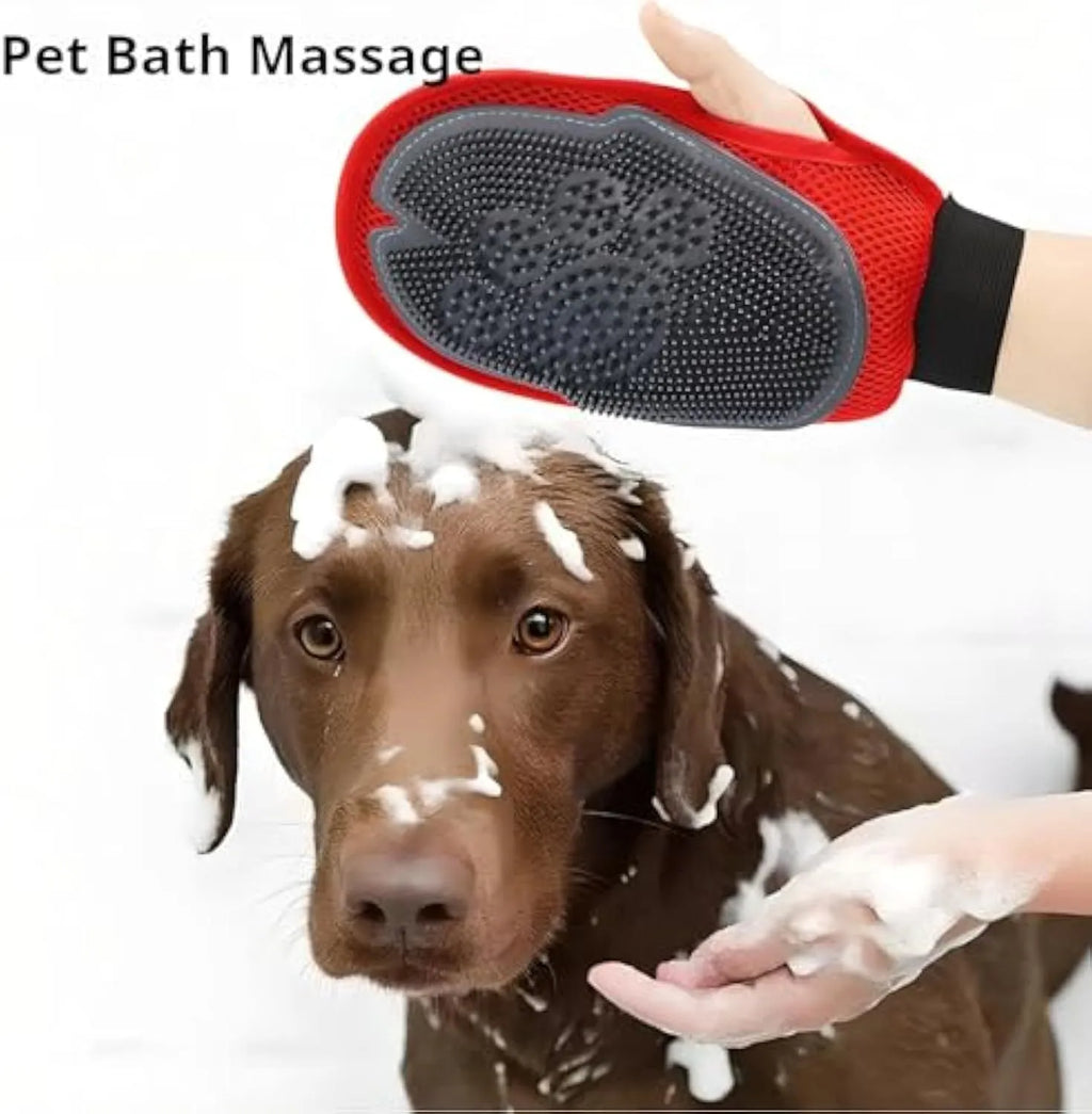 Red pet bathing and grooming glove with integrated brush, shown on a hand.