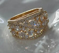Women's round hollow copper fashion ring with a choice of diamond or sapphire blue gemstone accent.