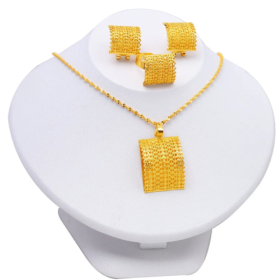 Gold-coloured bridal jewellery set with necklace, earrings, and ring on copper base