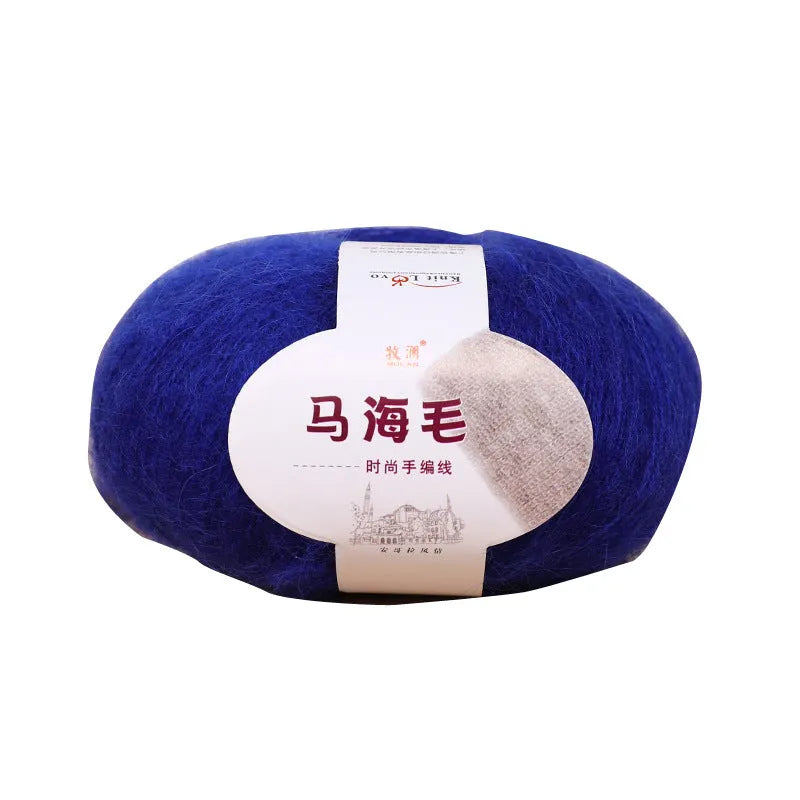 A ball of mohair thread in a chosen colour next to a hand-woven textured scarf sample.