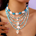 Blue electroplated women's necklace set with starfish and conch shell beads on adjustable chain