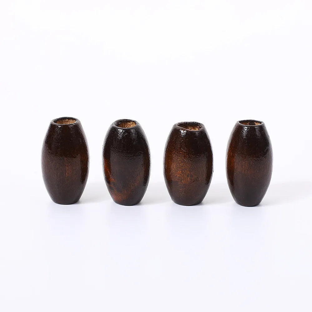 Dark brown oval wooden bead with raised M-shaped profile on a white background.