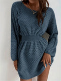 Blue knitted dress with fitted waist, round neck, long sleeves, and white crocheted flower details.