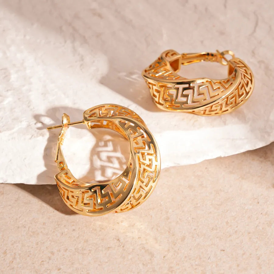 Women's geometric hollow stud earrings with twisted round design in gold and silver options