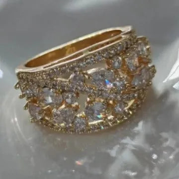 Women's round hollow copper fashion ring with a choice of diamond or sapphire blue gemstone accent.