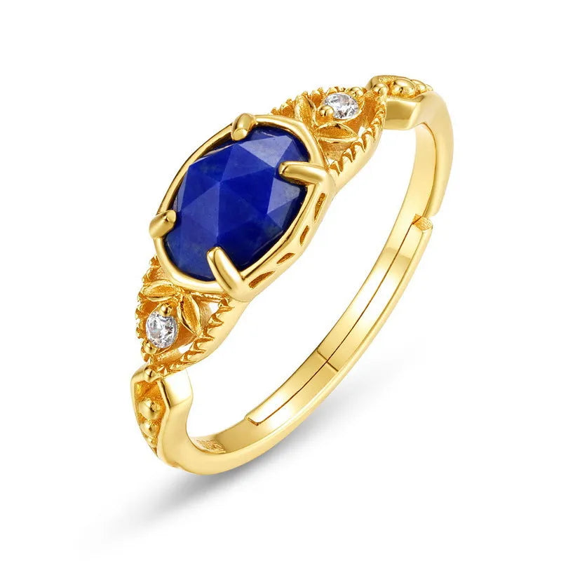 A geometric silver-tone alloy ring in a lapis lazuli colour, showing its elliptical profile and rounded elements.