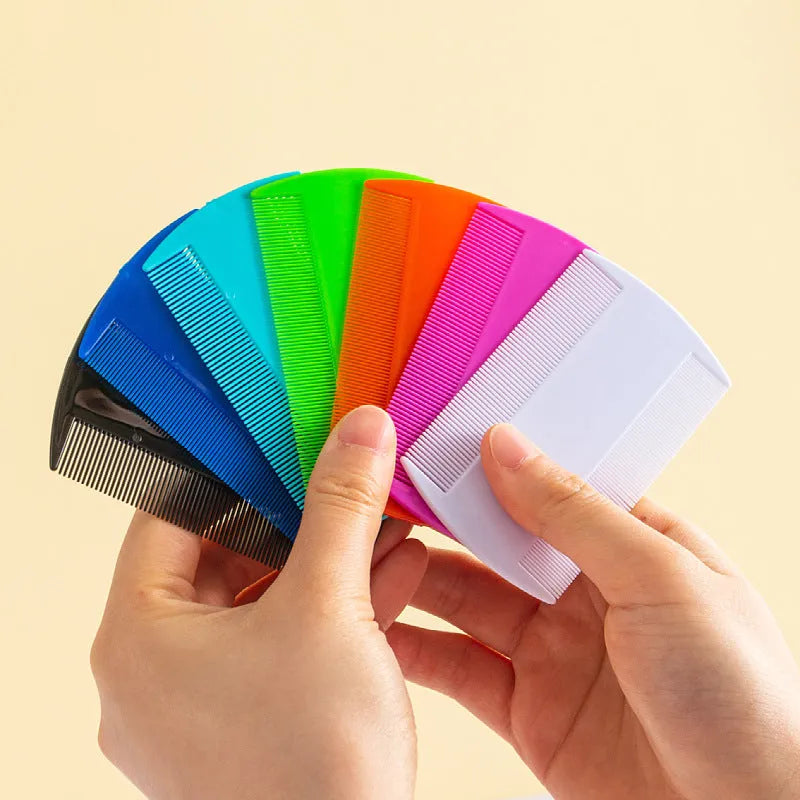 A white double-sided fine-toothed plastic comb for lice and flea detection on a plain background.