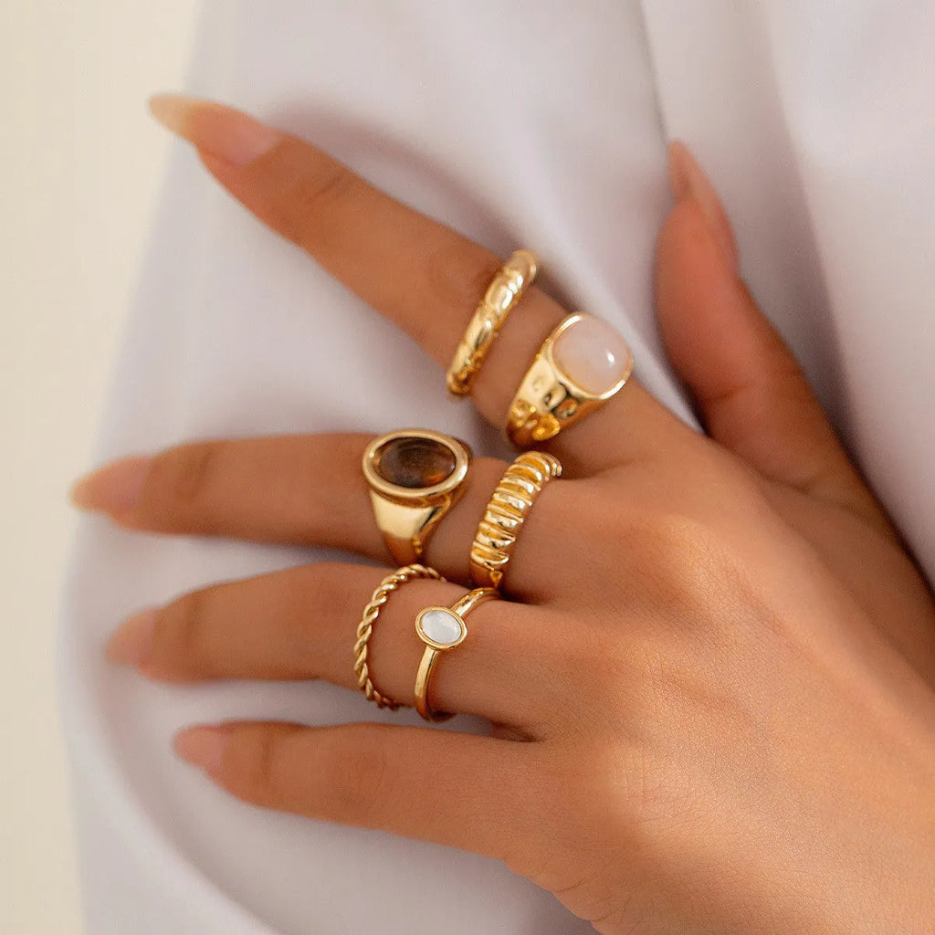 Six light gold electroplated alloy rings in a geometric set with round and ring shapes, style 94509