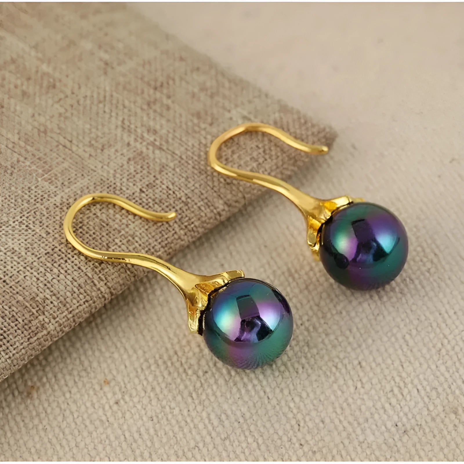 A pair of retro-style women's fashion earrings with an imitation gold electroplated finish.