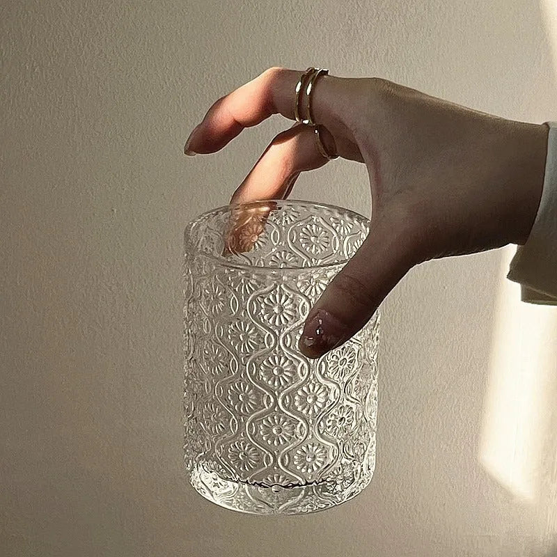 Clear glass water cup with carved Begonia flower pattern, shown in short and tall sizes.