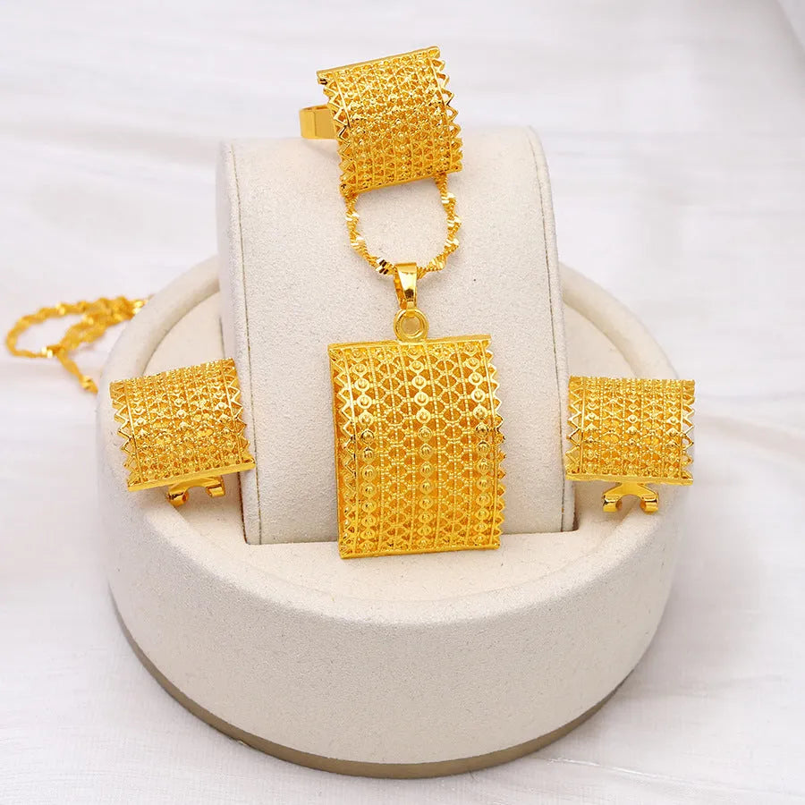 Gold-coloured bridal jewellery set with necklace, earrings, and ring on copper base