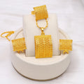 Gold-coloured bridal jewellery set with necklace, earrings, and ring on copper base