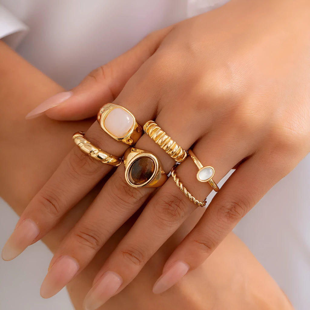 Six light gold electroplated alloy rings in a geometric set with round and ring shapes, style 94509