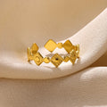 Geometric titanium steel women's ring with gold diamond accents on finger
