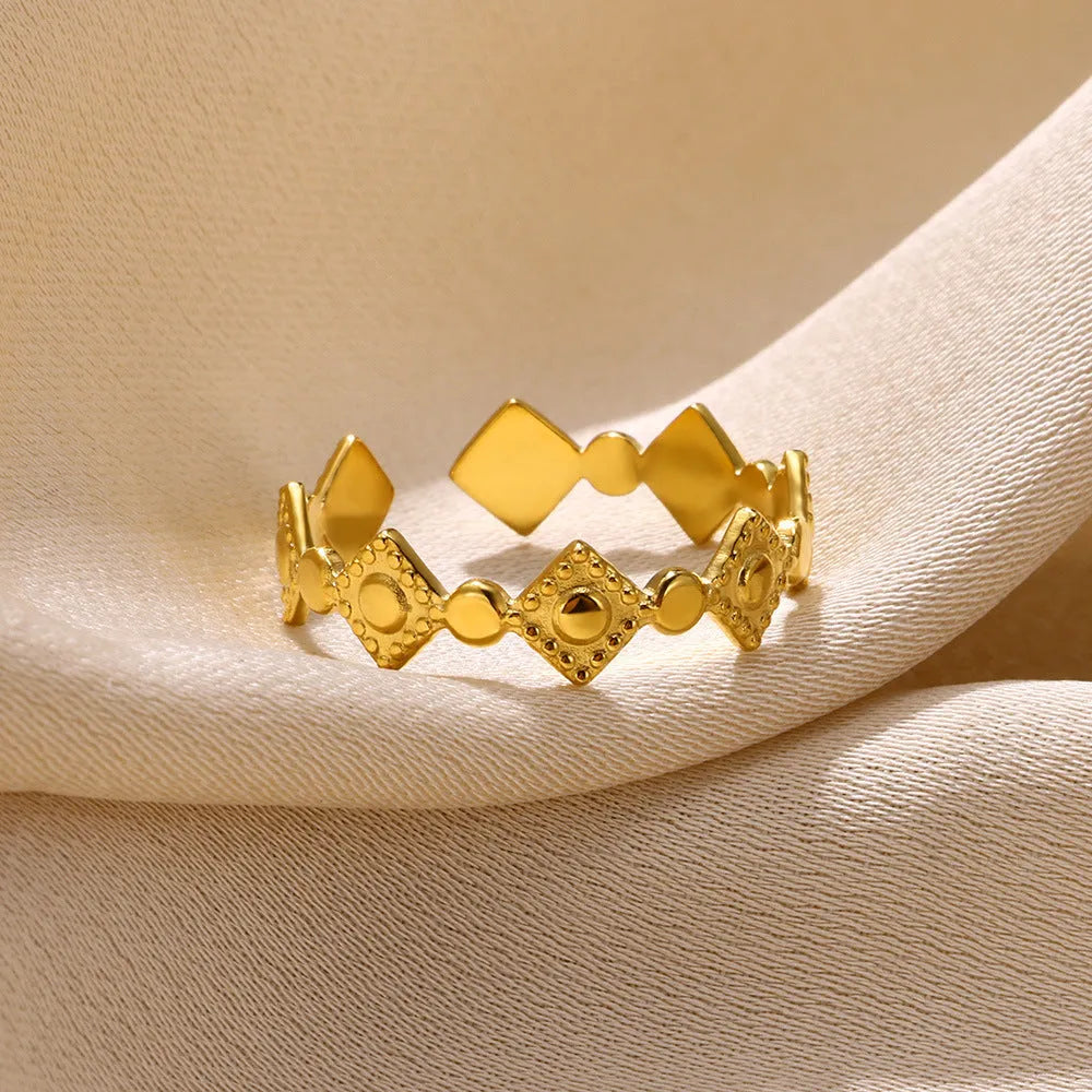 Geometric titanium steel women's ring with gold diamond accents on finger