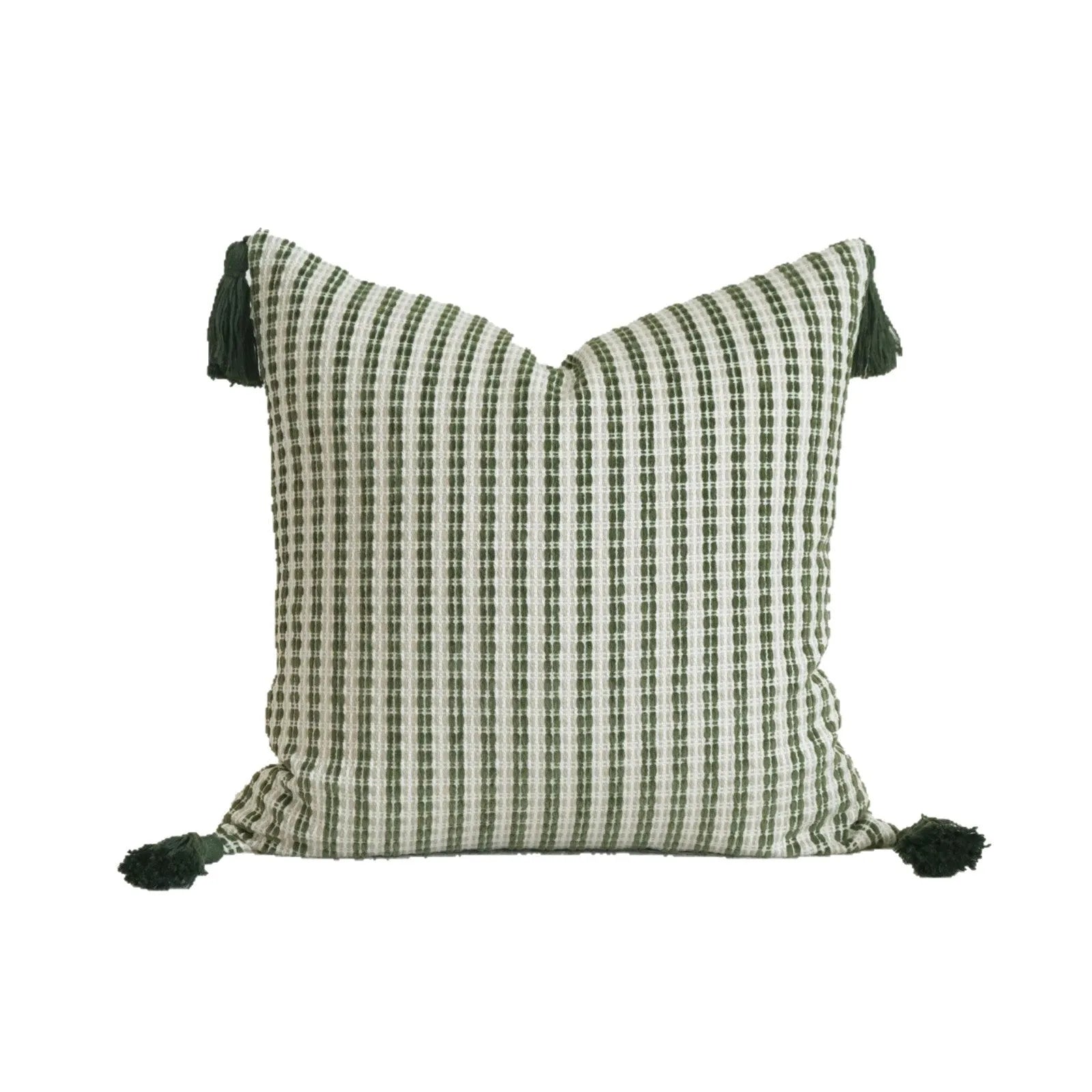 Green striped and botanical patterned pillow with beaded fringe on a bed.