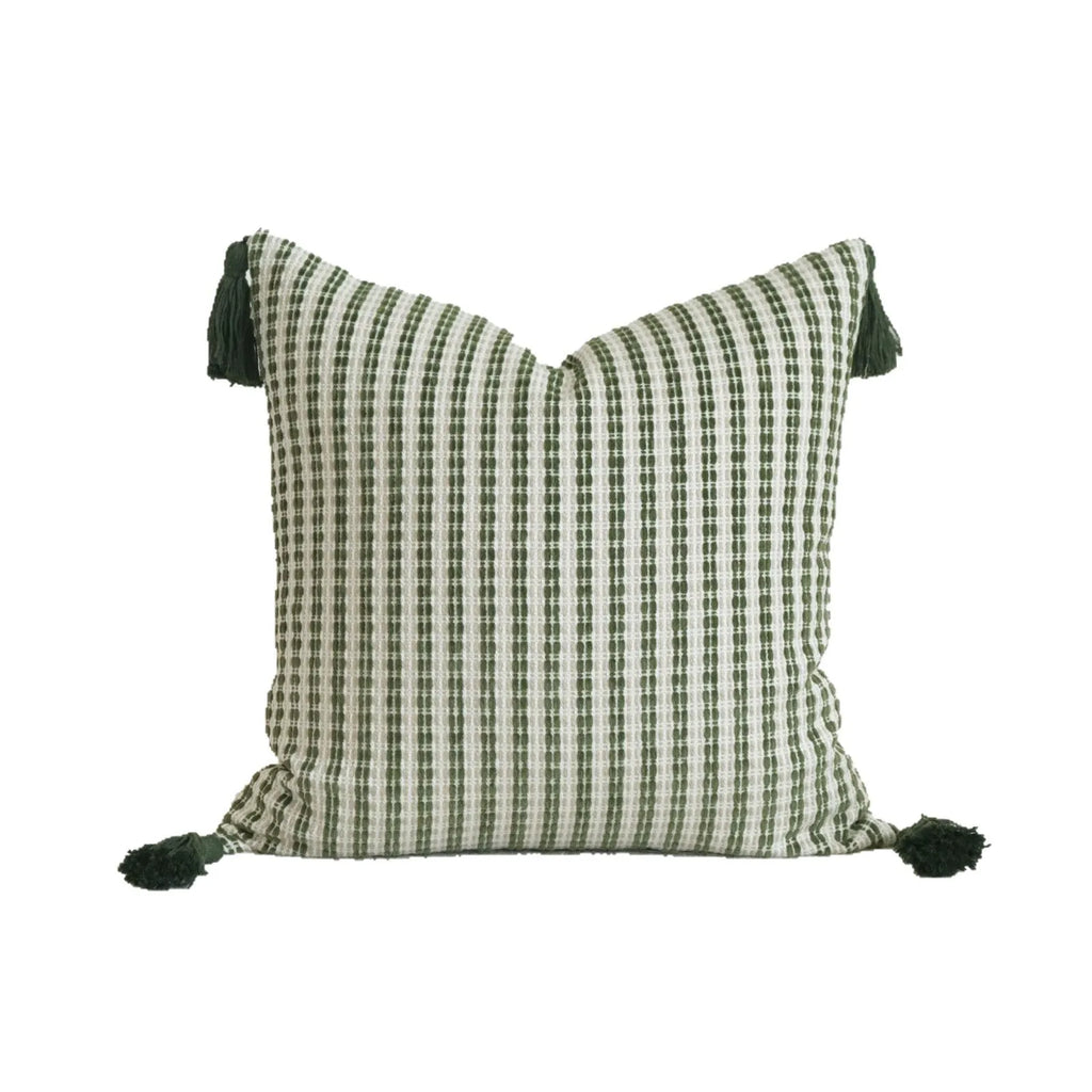 Green striped cotton linen decorative pillow with tassels next to a matching brushed fabric pillow core.