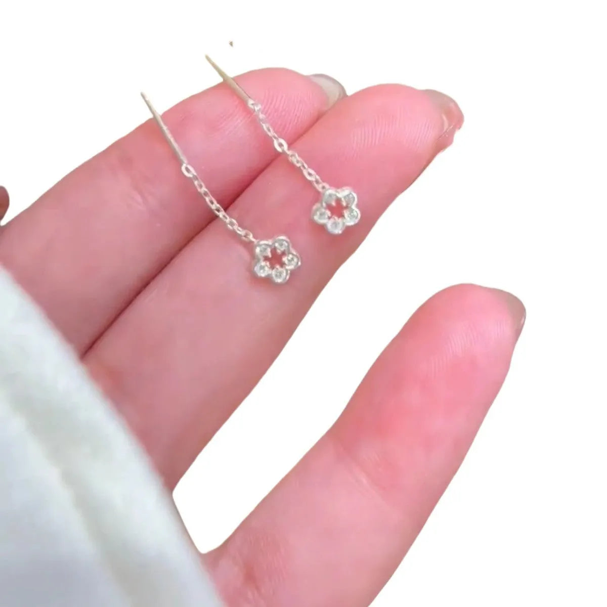 Silver-coloured alloy hollow flower hanging earrings with petal details on sterling silver needles
