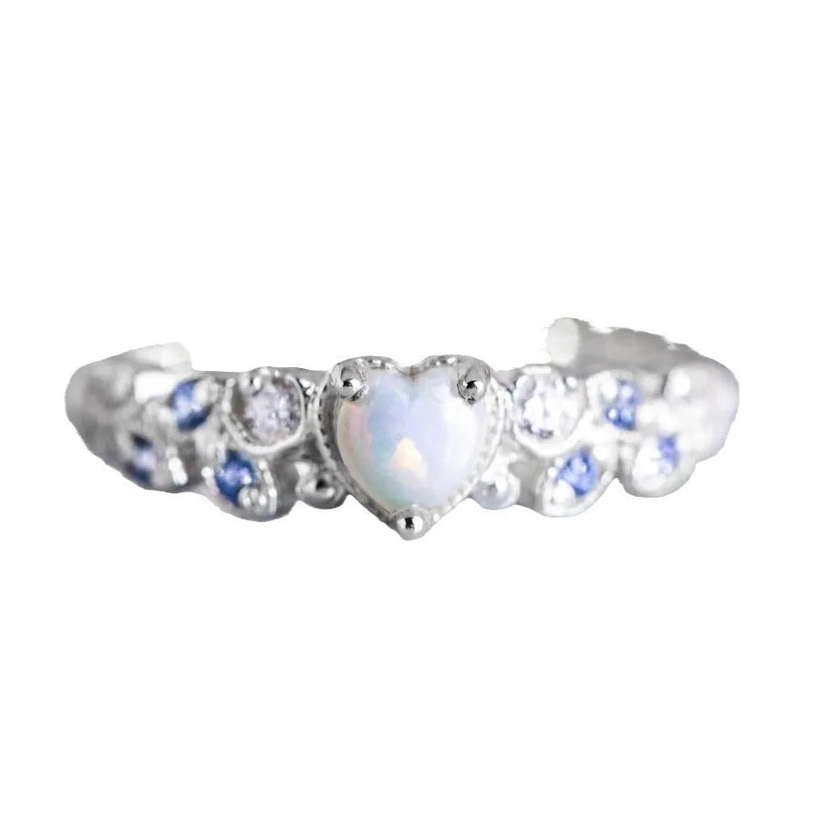 White electroplated alloy heart ring with detailed peach heart, opal stone, and floral ocean design.