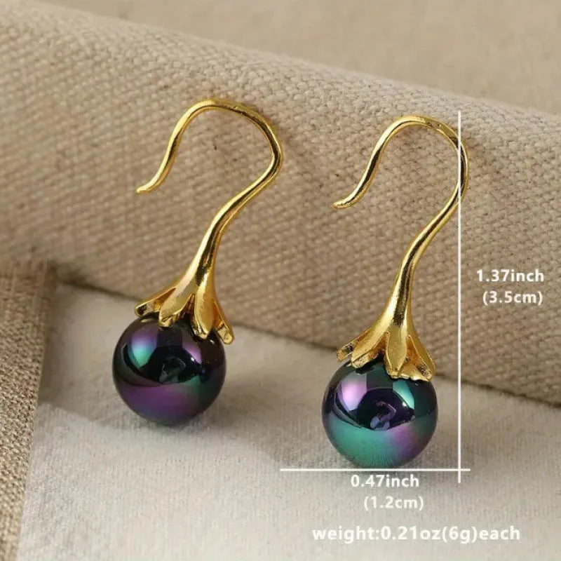 A pair of retro-style women's fashion earrings with an imitation gold electroplated finish.