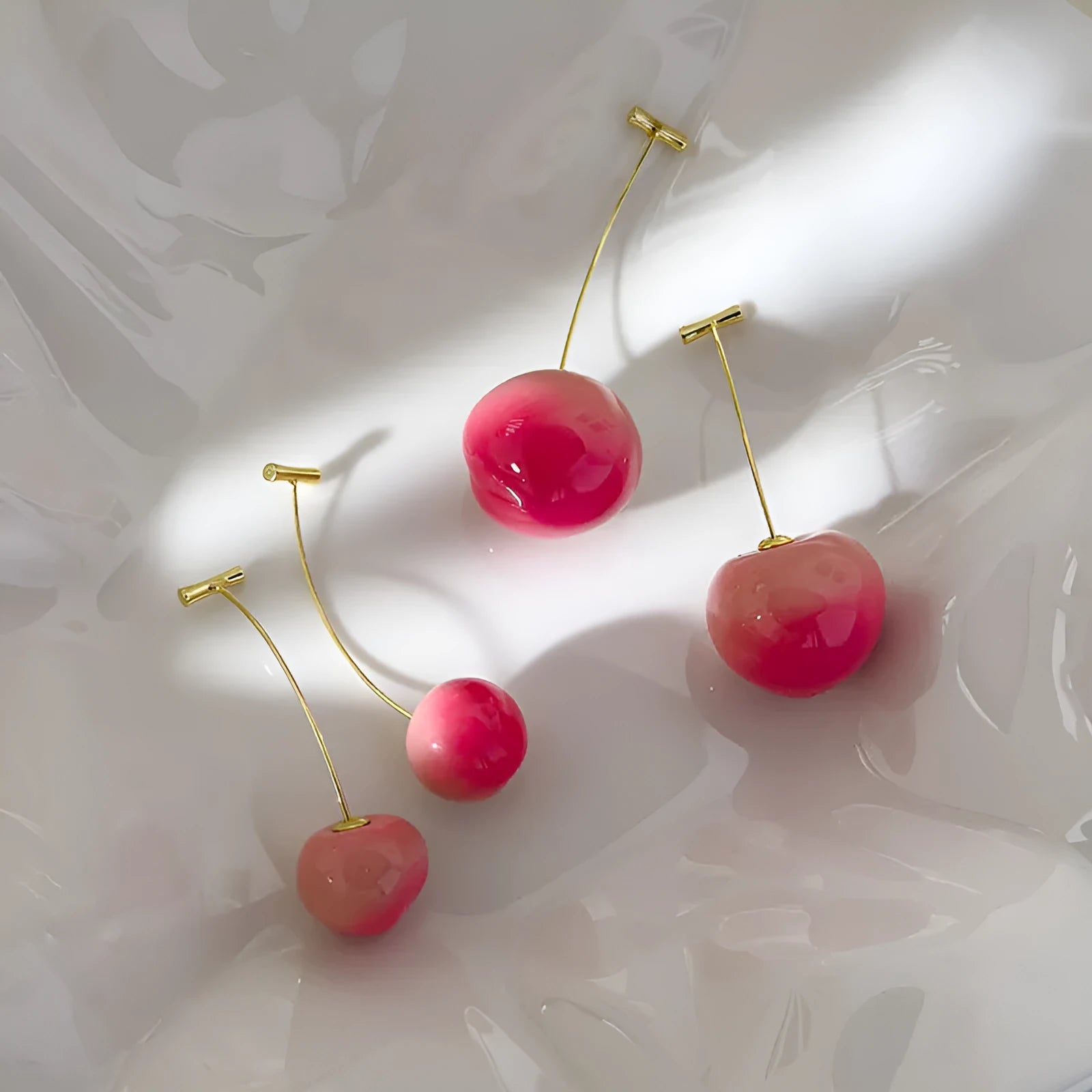 Gold-tone acrylic peach fruit earrings for women in small and large sizes.