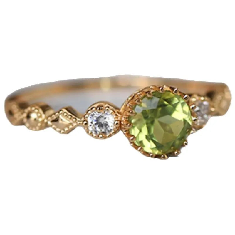 Copper ring with a green quadrilateral imitation peridot stone in a geometric Japanese retro style.