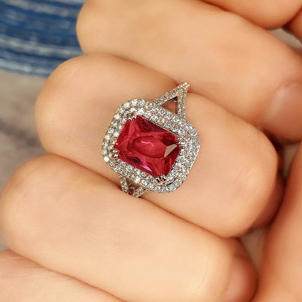 Women's copper ring with a square red rhinestone centrepiece on a geometric band.