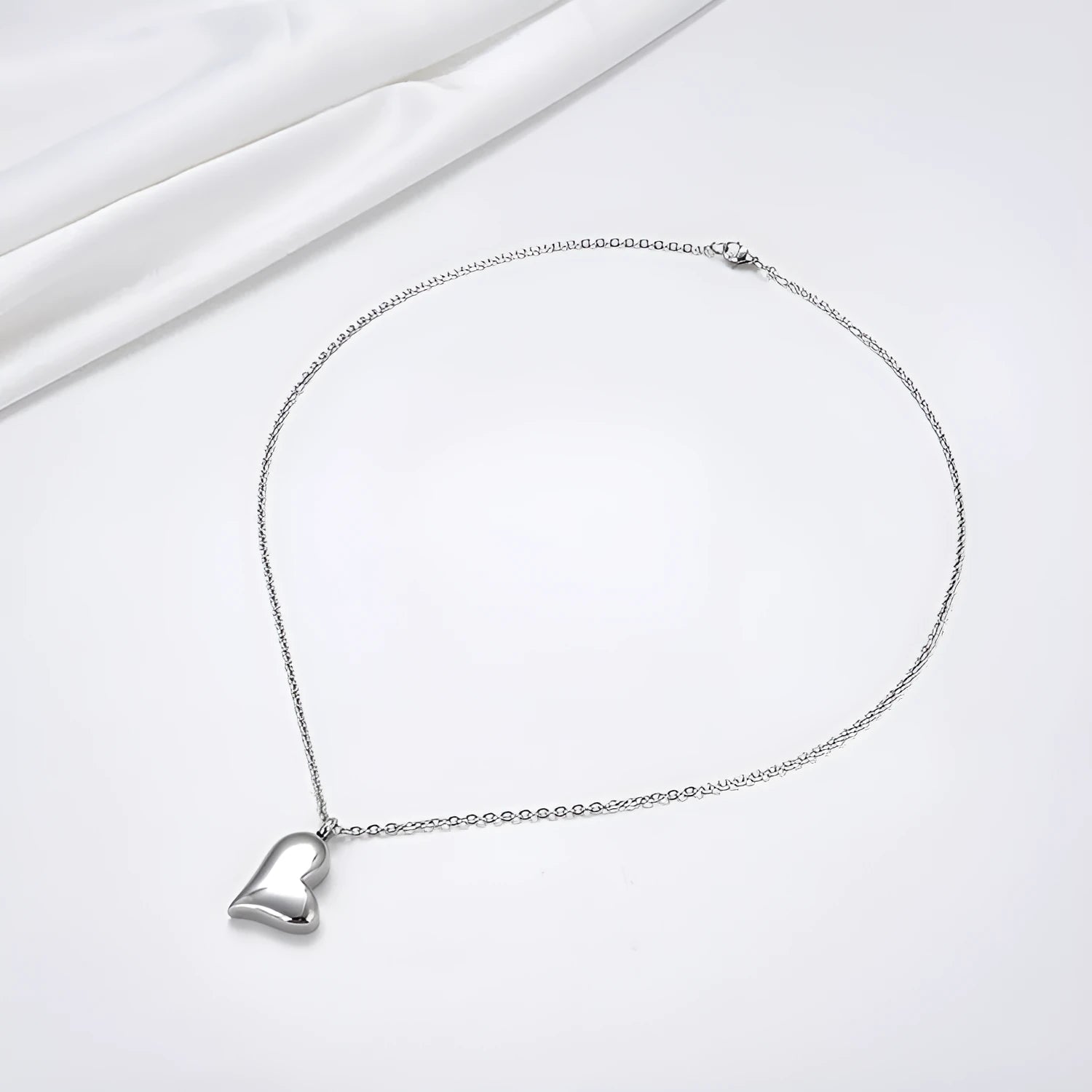 Curved peach heart silver necklace with stainless steel chain and adjustable extension