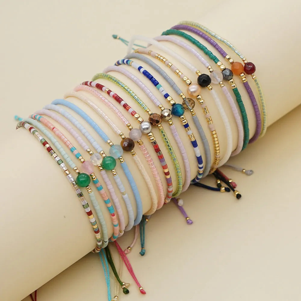 Handmade bohemian style bracelet with geometric glass and coloured glaze beads in various colours
